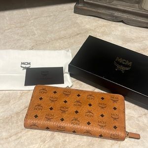 New in box MCM signature leather zip around wallet in cognac with black monogram